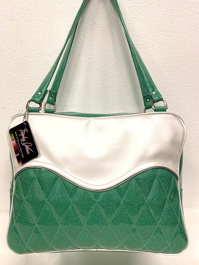 Diamond Pleat Tuck and Roll Business Bag comes in Sea Foam Green Glitter with Pearl White  and plush leopard lining, 29” straps with nickel hardware and comes with extra replacement straps! Inside has an open divided pocket and zipper pocket with hidden serial number. Tote comes with vinyl zipper pull, nickel fee and signature Trophy Queen label. Made with love in California.