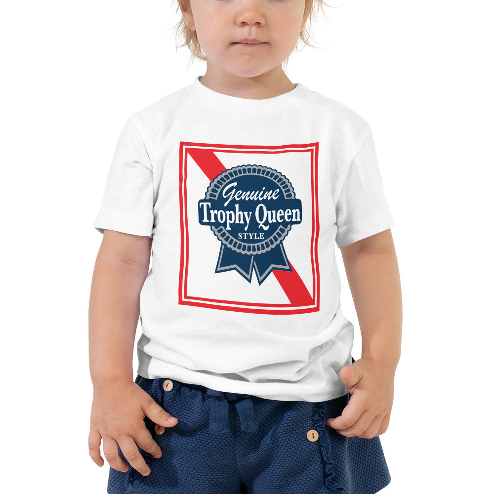 Let your toddler do their thing while feeling super comfy and looking extra stylish in this short-sleeve jersey t-shirt made from pre-shrunk, 100% cotton with a unique print of the Trophy Queen Blue Ribbon Logo. The tee is soft, durable, relaxed fit for extra comfort, and bound to become the staple of your toddlers wardrobe.