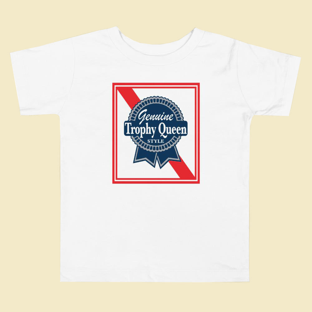 Let your toddler do their thing while feeling super comfy and looking extra stylish in this short-sleeve jersey t-shirt made from pre-shrunk, 100% cotton with a unique print of the Trophy Queen Blue Ribbon Logo. The tee is soft, durable, relaxed fit for extra comfort, and bound to become the staple of your toddlers wardrobe.