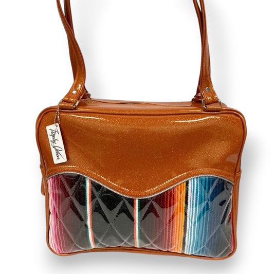 Diamond Pleat Tuck and Roll Business Bag comes in Tangerine Glitter Vinyl and Mexican Blanket with plush leopard lining, 29” straps with nickel hardware and comes with extra replacement straps! Inside has an open divided pocket and zipper pocket with hidden serial number. Tote comes with vinyl zipper pull, nickel fee and signature Trophy Queen label. American Made