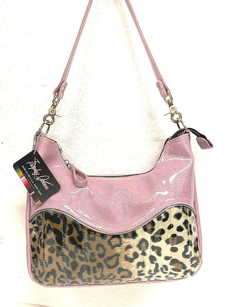 El Dorado Hobo Bag in Leopard and Blush Pink Glitter with plush leopard print lining handcrafted in California measuring approximately 12”x9”x2.5” (30.5cm x 23cm x 6cm) with inside open divided pocket and inside zipper pocket with inside hidden serial number and 26” should strap. Tote comes with vinyl zipper pull, nickel fee and signature Trophy Queen label. 