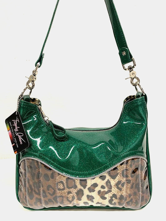El Dorado Hobo Bag in Leopard and Green Glitter Vinyl with plush leopard print lining handcrafted in California measuring approximately 12”x9”x2.5” (30.5cm x 23cm x 6cm) with inside open divided pocket and inside zipper pocket with inside hidden serial number and 26” should strap. Tote comes with vinyl zipper pull, nickel fee and signature Trophy Queen label.
