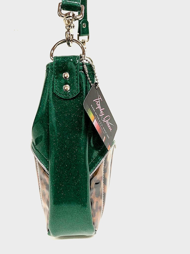 El Dorado Hobo Bag in Leopard and Green Glitter Vinyl with plush leopard print lining handcrafted in California measuring approximately 12”x9”x2.5” (30.5cm x 23cm x 6cm) with inside open divided pocket and inside zipper pocket with inside hidden serial number and 26” should strap. Tote comes with vinyl zipper pull, nickel fee and signature Trophy Queen label.