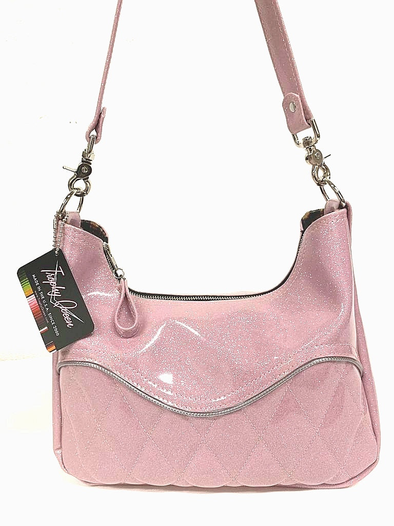 Diamond pleat El Dorado hobo bag in blush pink glitter vinyl and lined with plush leopard handcrafted in California. Medium size featuring 26” shoulder strap, insize open divided pocket and inside zipper pocket. Signature Trophy Queen label inside and hidden serial number.