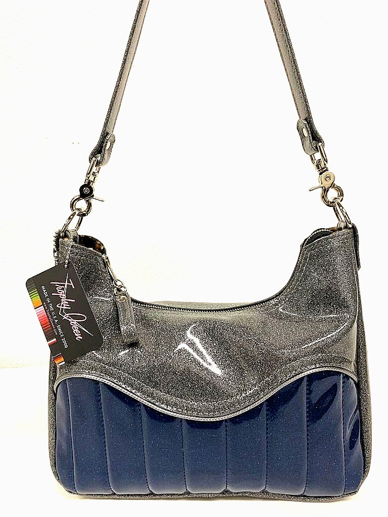 El Dorado Hobo Bag in Blue and Light Gray Glitter Vinyl with plush leopard print lining handcrafted in California measuring approximately 12”x9”x2.5” (30.5cm x 23cm x 6cm) with inside open divided pocket and inside zipper pocket with inside hidden serial number and 26” should strap. Tote comes with vinyl zipper pull, nickel fee and signature Trophy Queen label. 