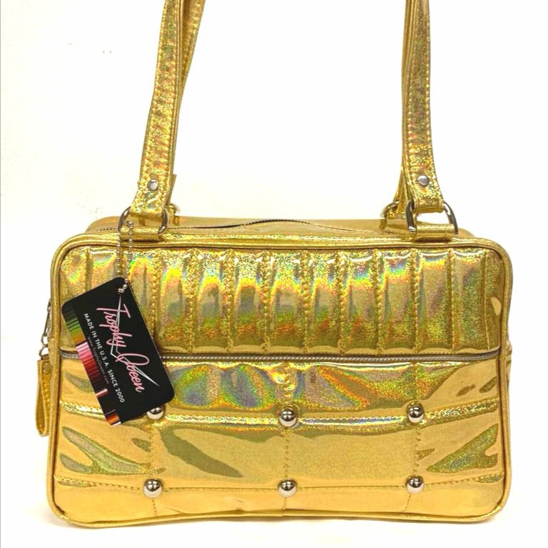 Lincoln Tote in Limited Edition Cosmic Gold Vinyl and Plush Leopard Lining. Made matching vinyl zipper pull, nickel feet, inside zipper pocket with serial number and open divided pocket with signature Trophy Queen label. The straps are approximately 25” and come with an extra set of replacement straps. Locally made and ships from California