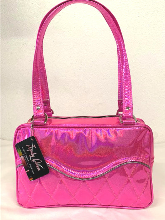 Limited Edition Color the Diamond Pleat Tuck and Roll Tote in Cosmic Pink Glitter Vinyl and plush leopard lining is handcrafted in California with nickel hardware and 25” straps plus it comes with replacement straps. Inside open divided pocket and inside zipper pocket with serial number hidden inside. Nickel feet, vinyl zipper pull, and signature Trophy Queen Label included. The perfect size bag for any trip!
