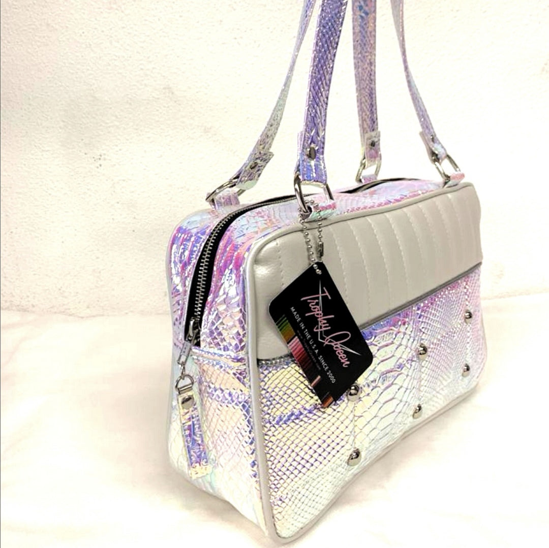 Lincoln Tote in Limited Edition Mermaid and Pearl White Vinyl with Plush Leopard Lining. Matching vinyl zipper pull, nickel feet, inside zipper pocket with serial number and open divided pocket with signature Trophy Queen label. The straps are approximately 25” and come with an extra set of replacement straps. Locally made and ships from California