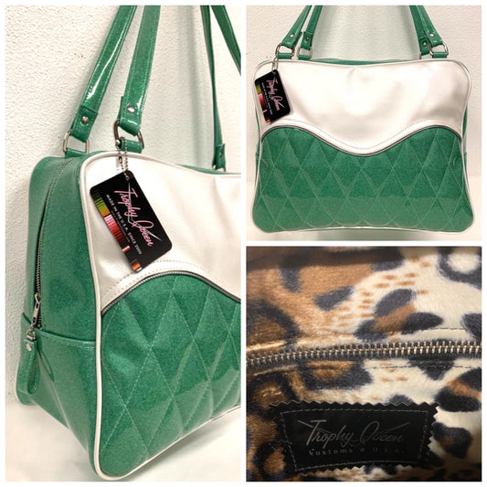 Diamond Pleat Tuck and Roll Business Bag comes in Sea Foam Green Glitter with Pearl White  and plush leopard lining, 29” straps with nickel hardware and comes with extra replacement straps! Inside has an open divided pocket and zipper pocket with hidden serial number. Tote comes with vinyl zipper pull, nickel fee and signature Trophy Queen label. Made with love in California.