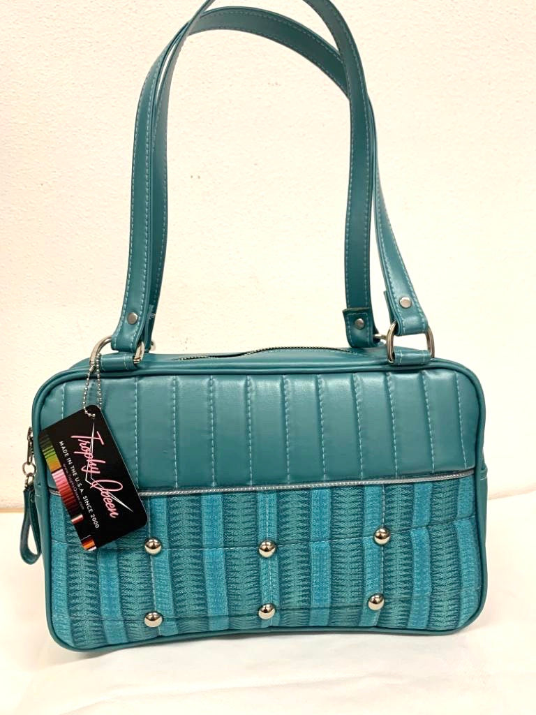 Lincoln Tote in Limited Edition Vintage Turquoise ‘65 Chevy Fabric and Vintage Turquoise Vinyl with Plush Leopard Lining. Made from NOS Vintage 1965 Chevy Upholstery Fabric with matching vinyl zipper pull, nickel feet, inside zipper pocket with serial number and open divided pocket with signature Trophy Queen label. The straps are approximately 25” and come with an extra set of replacement straps. Locally made and ships from California