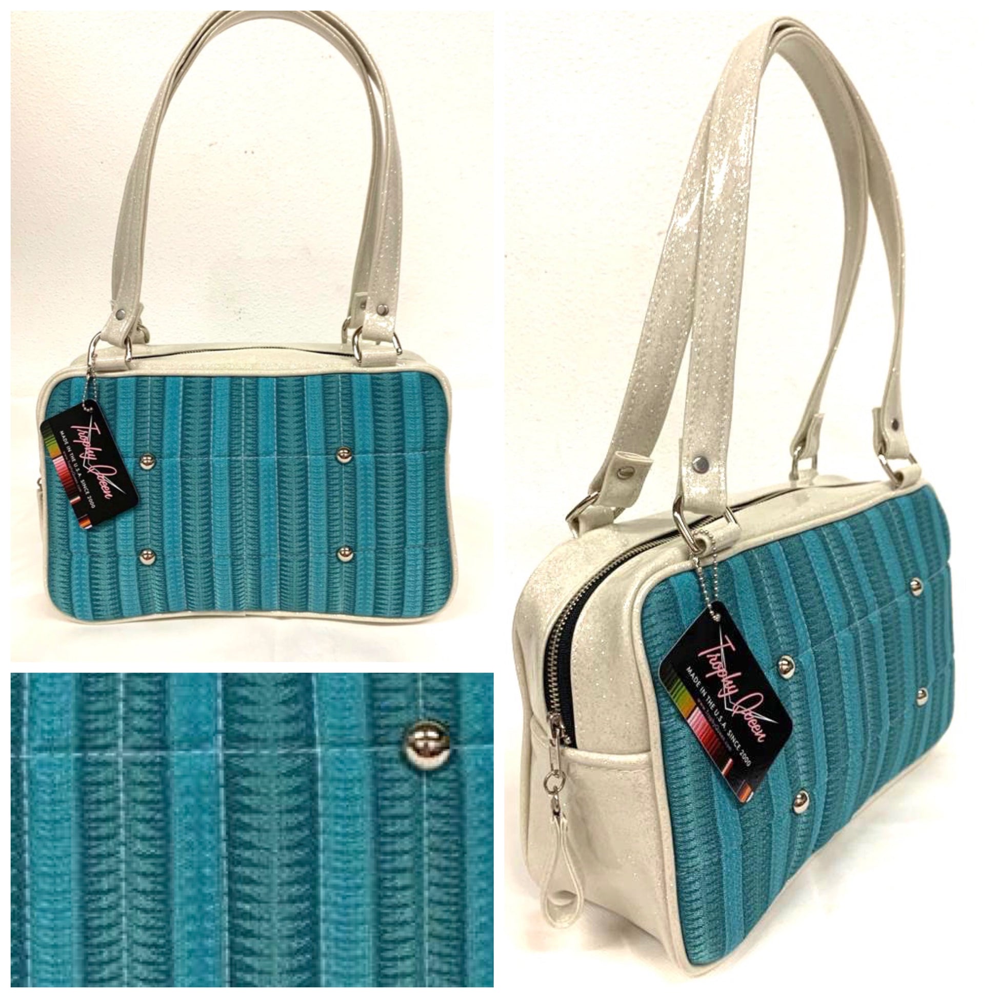 Galaxy Tote, slightly larger than the Galaxy Shoulder Bag in Limited Edition Turquoise ‘65 Chevy Fabric with White Glitter Vinyl and Plush Leopard Lining. Made from NOS Vintage 1965 Chevy Upholstery Fabric with nickel hardware and nickel feet, vinyl zipper pull, and 25” (61cm) straps. Inside you’ll find an open divided pocket, a zipper pocket with serial number inside and signature Trophy Queen Label. Ships from California with an extra set of replacement straps.