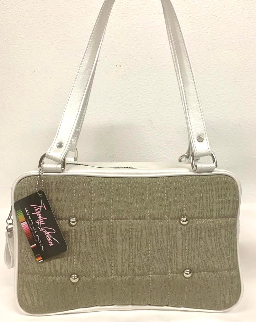 Galaxy Tote, slightly larger than the Galaxy Shoulder Bag in Limited Edition Tan ‘69 Buick Fabric with Pearl White Glitter Vinyl and Plush Leopard Lining. Made from NOS Vintage 1969 Buick LeSabre Upholstery fabric with nickel hardware and nickel feet, vinyl zipper pull, and 25” (61cm) straps. Inside you’ll find an open divided pocket, a zipper pocket with serial number inside and signature Trophy Queen Label. Ships from California with an extra set of replacement straps.