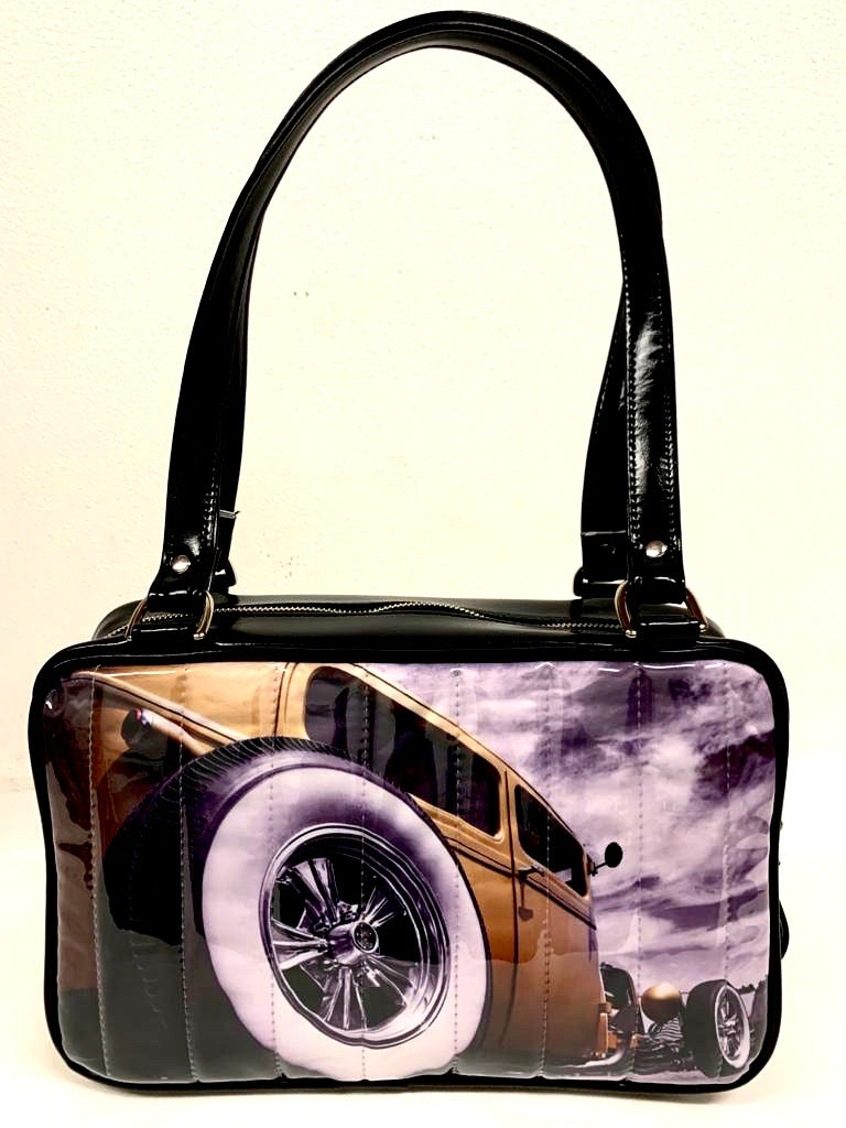 Limited Edition Hot Rod Tote in White Glitter and Grease Black Vinyl with Plush Leopard Lining. The Back Panel Features Hot Rod Photo by April May Photography. This unique bag has a matching vinyl zipper pull, nickel feet, inside zipper pocket with serial number and open divided pocket with signature Trophy Queen label. The straps are approximately 25” and come with an extra set of replacement straps. Locally made and ships from California.