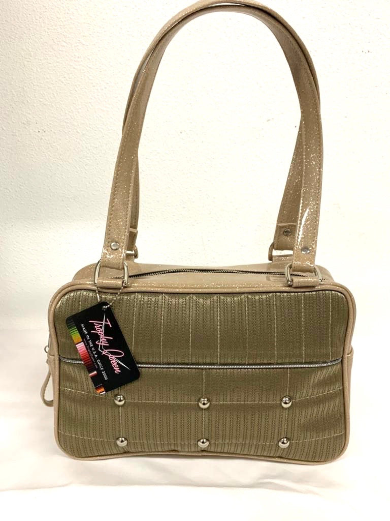 Lincoln Tote in Limited Edition Vintage Gold ‘64 Buick Fabric and Champagne Glitter Vinyl with Plush Leopard Lining. Made from NOS Vintage 1964 Buick Skylark Upholstery Fabric with matching vinyl zipper pull, nickel feet, inside zipper pocket with serial number and open divided pocket with signature Trophy Queen label. The straps are approximately 25” and come with an extra set of replacement straps. Locally made and ships from California