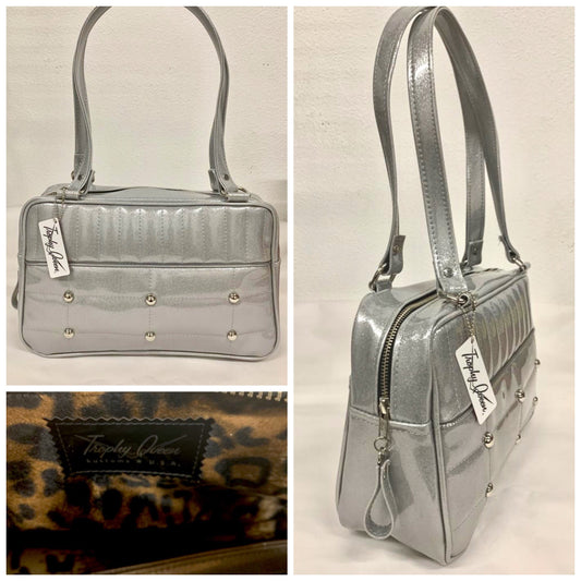 Lincoln Tote in Chrome Glitter Vinyl and Plush Leopard Lining. Made matching vinyl zipper pull, nickel feet, inside zipper pocket with serial number and open divided pocket with signature Trophy Queen label. The straps are approximately 25” and come with an extra set of replacement straps. Locally made and ships from California