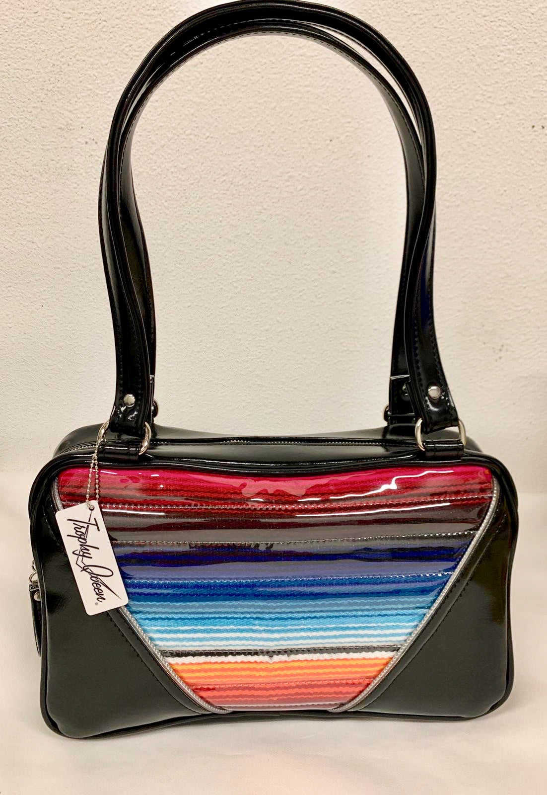 Comet Tote in Mexican blanket with clear overlay and grease black vinyl with plush leopard lining handcrafted in California with nickel hardware, an extra set of straps, vinyl zipper pull, inside open divided pocket, zipper pocket with serial number inside and signature Trophy Queen label.