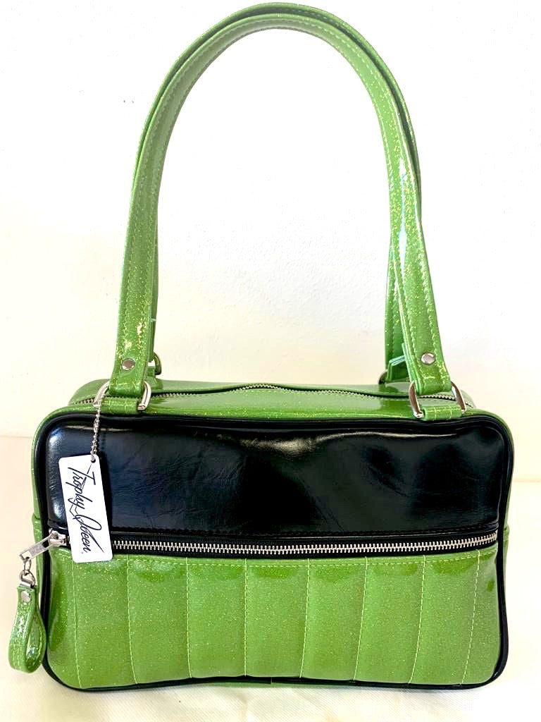 Fairlane Tote Bag in Lime Green Glitter Vinyl and Grease Black Vinyl with plush Leopard Lining. This purse has matching vinyl zipper pull, nickel feet, inside zipper pocket with serial number and open divided pocket with signature Trophy Queen label. The straps are approximately 25” and come with an extra set of replacement straps. Locally made and ships from California.