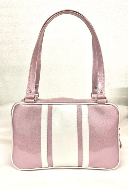 GTO Tote Bag in Blush Pink Glitter and Pearl White Vinyl with Plush Leopard Lining has matching vinyl zipper pull, nickel feet, inside zipper pocket with serial number and open divided pocket with signature Trophy Queen label. The straps are approximately 25” and come with an extra set of replacement straps. Locally made and ships from California.