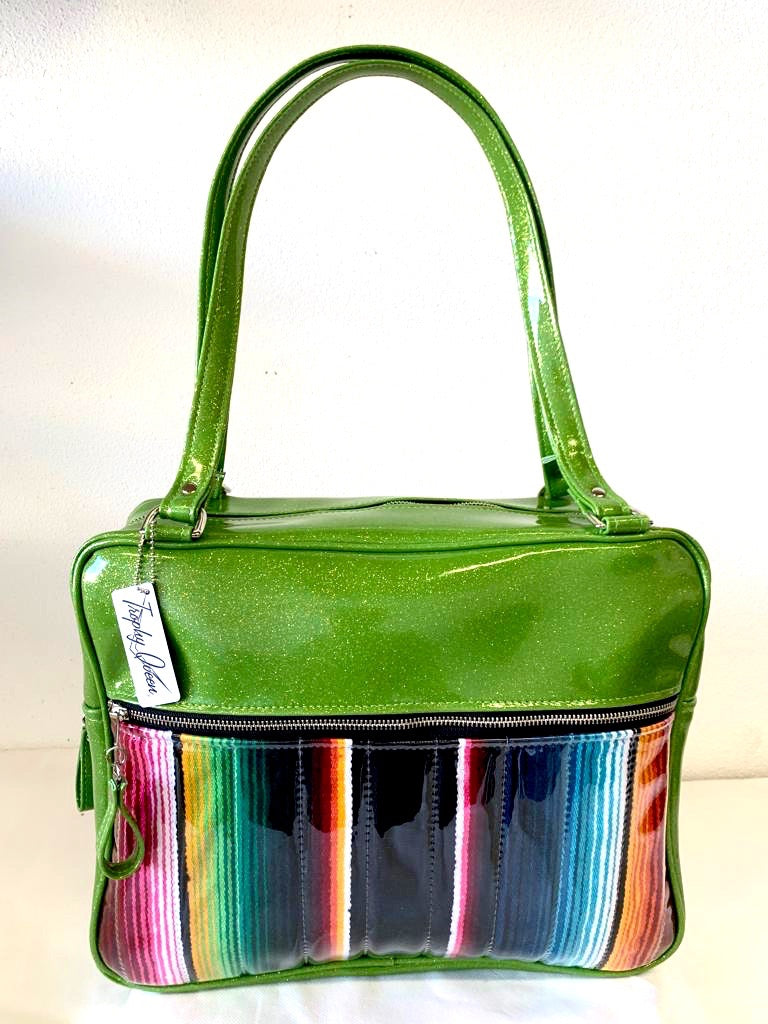 Fairlane Business Bag with Genuine Mexican Blanket with Clear Overlay and Lime Green Glitter Vinyl lined with plush Leopard fabric. The straps are 29” with nickel hardware and come with extra replacement straps! Inside has an open divided pocket and zipper pocket with hidden serial number. Tote comes with vinyl zipper pull, nickel fee and signature Trophy Queen label. Made with love in California.