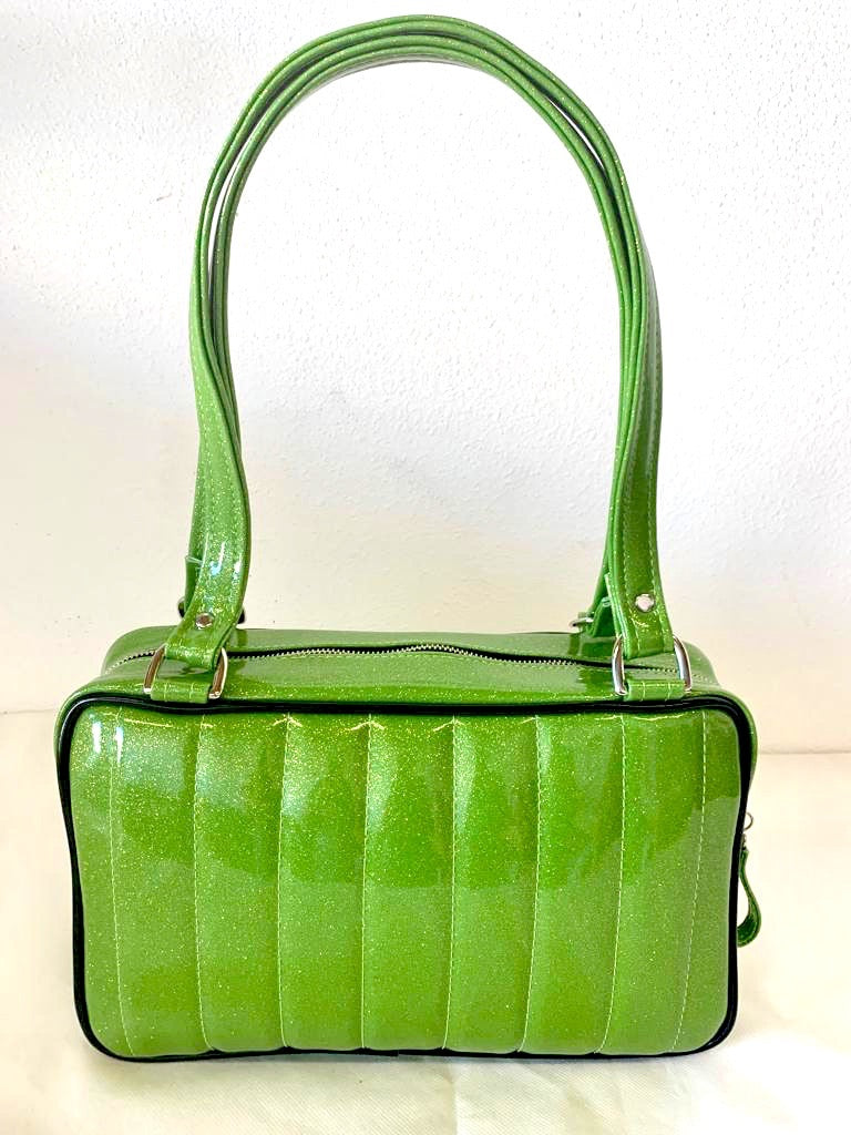 Fairlane Tote Bag in Lime Green Glitter Vinyl and Grease Black Vinyl with plush Leopard Lining. This purse has matching vinyl zipper pull, nickel feet, inside zipper pocket with serial number and open divided pocket with signature Trophy Queen label. The straps are approximately 25” and come with an extra set of replacement straps. Locally made and ships from California.