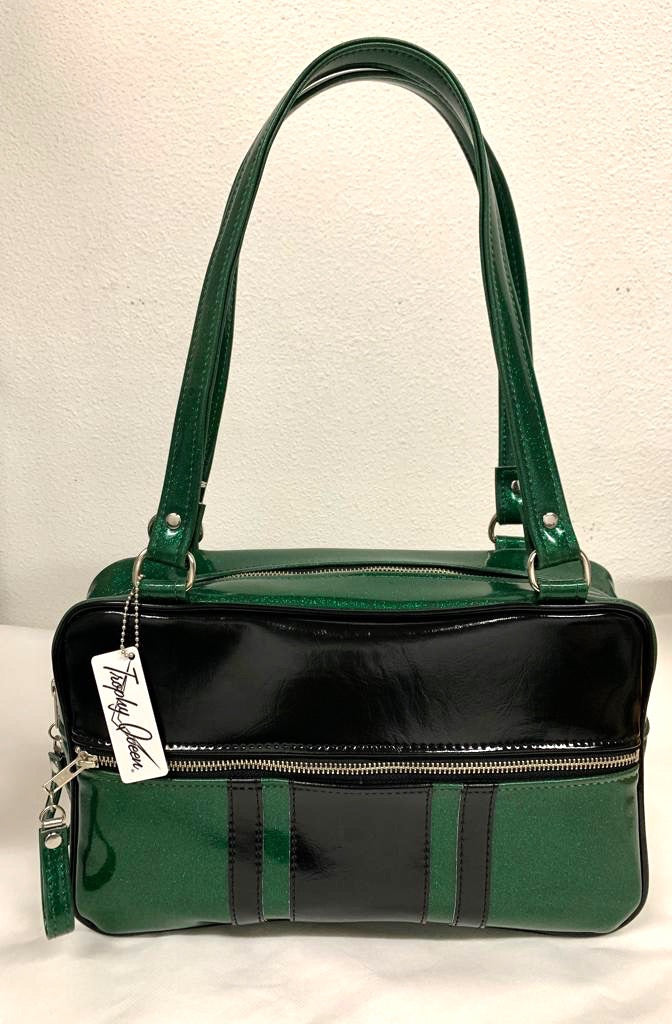 The Galaxy Tote Bag is slightly larger than the Galaxy Shoulder Bag in Green Glitter Vinyl and Grease Black Vinyl Stripes with Plush Leopard Lining. Made with nickel hardware and nickel feet, vinyl zipper pull, and 25” (61cm) straps. Inside you’ll find an open divided pocket, a zipper pocket with serial number inside and signature Trophy Queen Label. Ships from California with an extra set of replacement straps included.