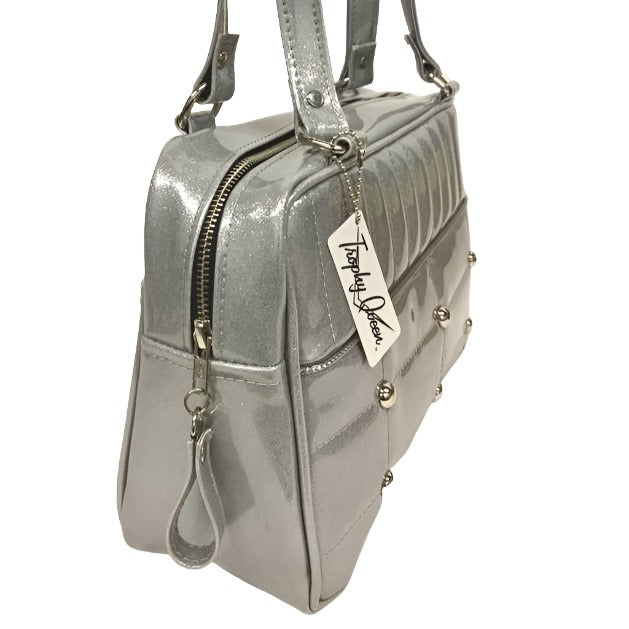 Lincoln Tote in Chrome Glitter Vinyl and Plush Leopard Lining. Made matching vinyl zipper pull, nickel feet, inside zipper pocket with serial number and open divided pocket with signature Trophy Queen label. The straps are approximately 25” and come with an extra set of replacement straps. Locally made and ships from California
