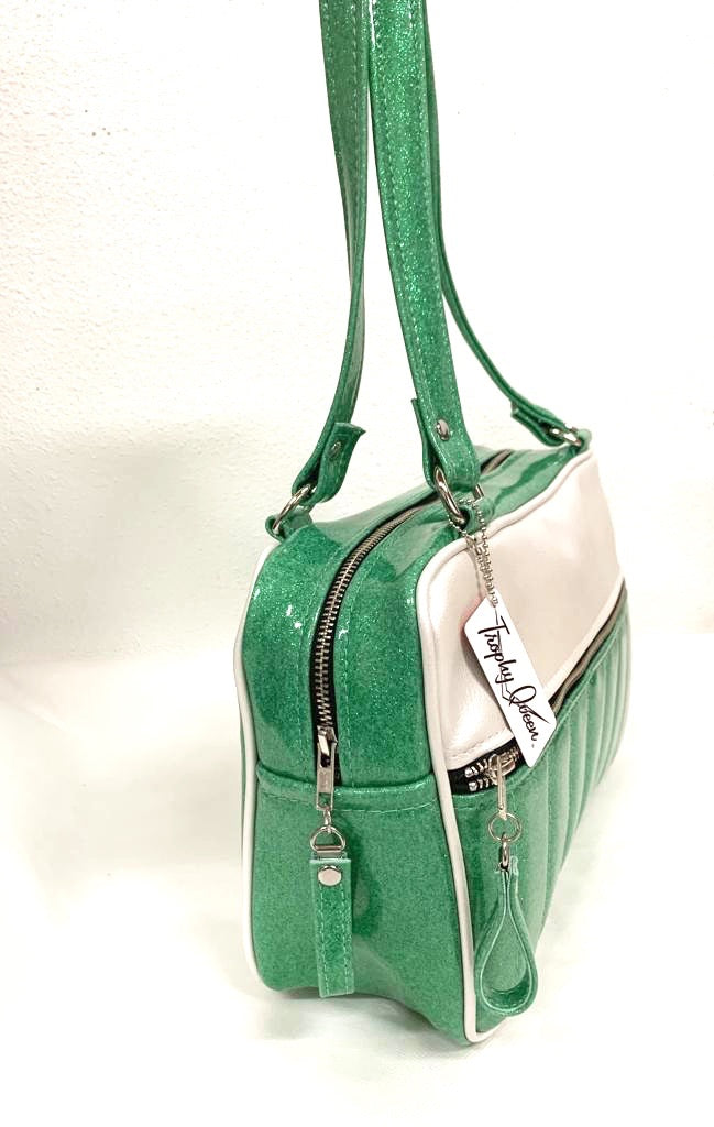 Fairlane Tote Bag in Seafoam Green Glitter and Pearl White Vinyl with plush Leopard Lining. This purse has matching vinyl zipper pull, nickel feet, inside zipper pocket with serial number and open divided pocket with signature Trophy Queen label. The straps are approximately 25” and come with an extra set of replacement straps. Locally made and ships from California.