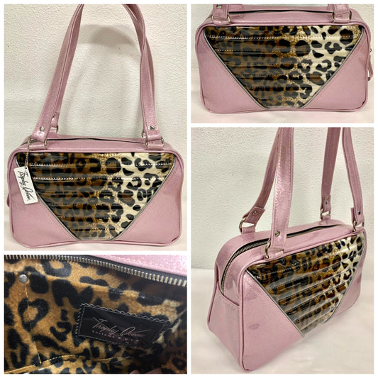 Comet Tote in blush pink glitter vinyl and plush leopard with clear overlay with plush leopard lining handcrafted in California with nickel hardware, an extra set of straps, vinyl zipper pull, inside open divided pocket, zipper pocket with serial number inside and signature Trophy Queen label.
