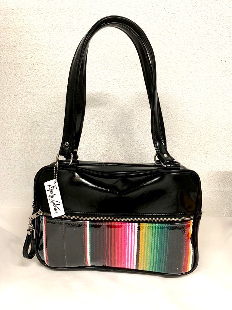 Fairlane Tote Bag in Genuine Mexican Blanket with Clear Overlay and Grease Black Vinyl with plush Leopard Lining. This purse has matching vinyl zipper pull, nickel feet, inside zipper pocket with serial number and open divided pocket with signature Trophy Queen label. The straps are approximately 25” and come with an extra set of replacement straps. Locally made and ships from California.