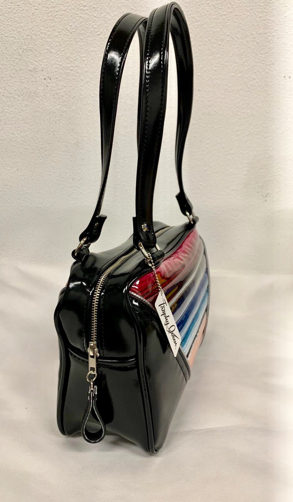Comet Tote in Mexican blanket with clear overlay and grease black vinyl with plush leopard lining handcrafted in California with nickel hardware, an extra set of straps, vinyl zipper pull, inside open divided pocket, zipper pocket with serial number inside and signature Trophy Queen label.