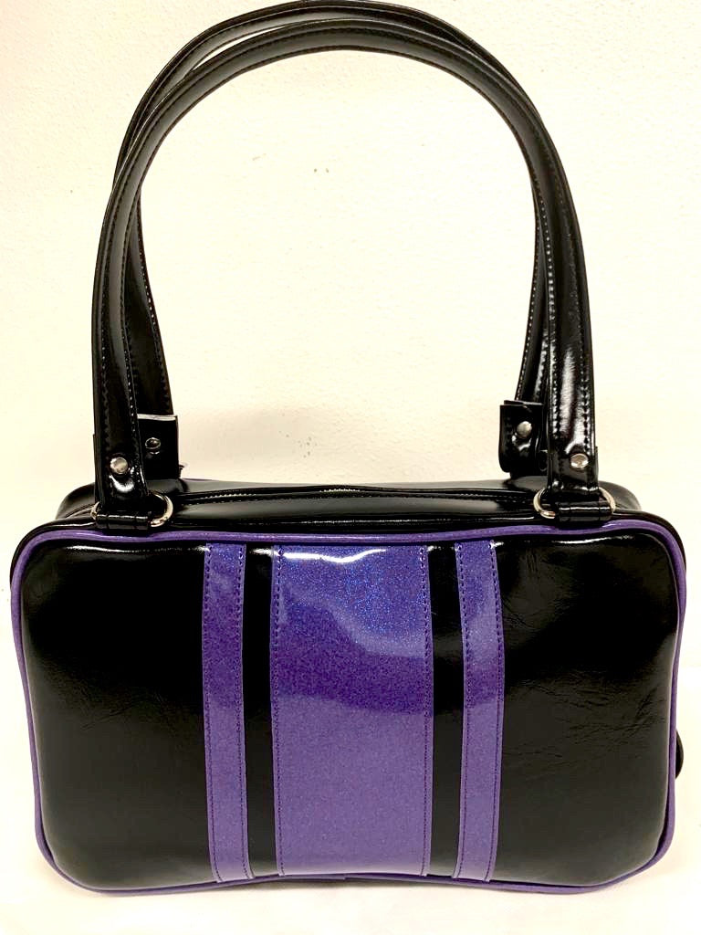 The Galaxy Tote Bag is slightly larger than the Galaxy Shoulder Bag in Grease Black and Beatnik Purple Glitter Vinyl Stripes withPlush Leopard Lining. Made with nickel hardware and nickel feet, vinyl zipper pull, and 25” (61cm) straps. Inside you’ll find an open divided pocket, a zipper pocket with serial number inside and signature Trophy Queen Label. Ships from California with an extra set of replacement straps included.