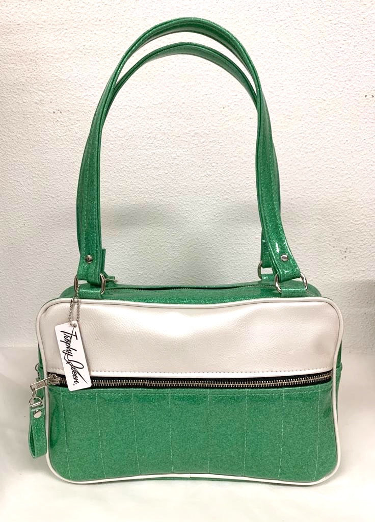 Fairlane Tote Bag in Seafoam Green Glitter and Pearl White Vinyl with plush Leopard Lining. This purse has matching vinyl zipper pull, nickel feet, inside zipper pocket with serial number and open divided pocket with signature Trophy Queen label. The straps are approximately 25” and come with an extra set of replacement straps. Locally made and ships from California.