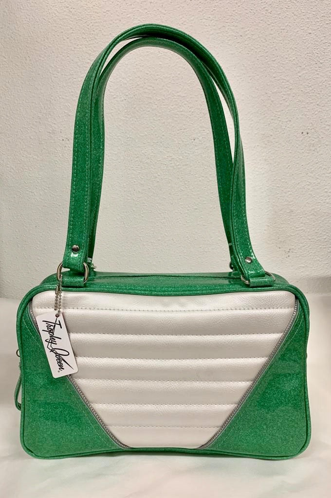 Comet Tote in sea foam green glitter vinyl and pearl white vinyl with plush leopard lining handcrafted in California with nickel hardware, an extra set of straps, vinyl zipper pull, inside open divided pocket, zipper pocket with serial number inside and signature Trophy Queen label.