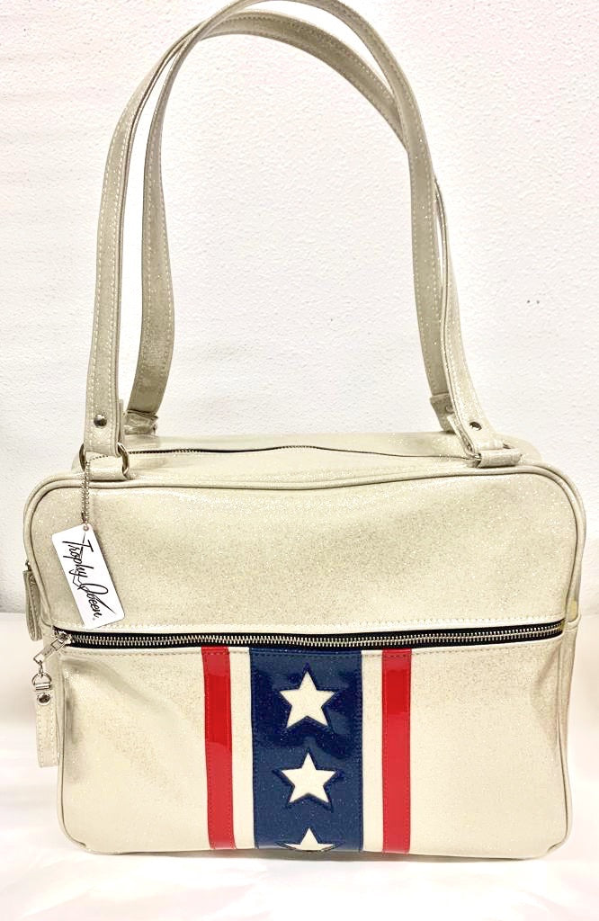 Evel Knievel GTO Business Bag with plush leopard lining, 29” straps with nickel hardware and comes with extra replacement straps! Inside has an open divided pocket and zipper pocket with hidden serial number. Tote comes with vinyl zipper pull, nickel fee and signature Trophy Queen label. Made with love in California.