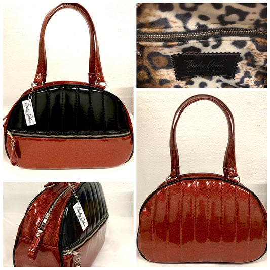 Lucky Strike Bowling Style Bag made with Red Glitter and Grease Black Vinyl and lined with Plush Leopard inside with front zipper pocket, shoulder straps with extra set included inside has divided pocket, zipper pocket with hidden serial number inside and signature trophy queen label.