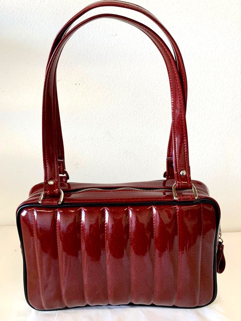 Fairlane Tote Bag in Red Glitter with Grease Black Vinyl with plush Leopard Lining. This purse has matching vinyl zipper pull, nickel feet, inside zipper pocket with serial number and open divided pocket with signature Trophy Queen label. The straps are approximately 25” and come with an extra set of replacement straps. Locally made and ships from California.