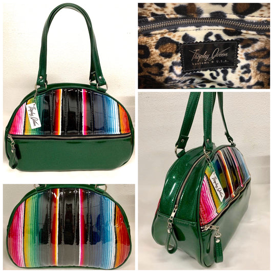 Lucky Strike Bowling Style Bag made with Dark Green Glitter and Mexican Blanket with Clear Overly Vinyl and lined with Plush Leopard inside with front zipper pocket, shoulder straps with extra set included inside has divided pocket, zipper pocket with hidden serial number inside and signature trophy queen label.