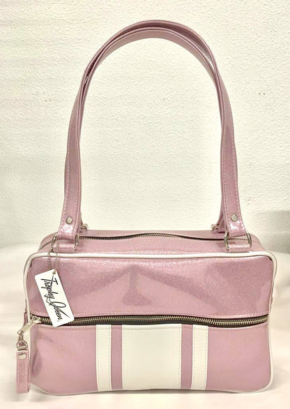 GTO Tote Bag in Blush Pink Glitter and Pearl White Vinyl with Plush Leopard Lining has matching vinyl zipper pull, nickel feet, inside zipper pocket with serial number and open divided pocket with signature Trophy Queen label. The straps are approximately 25” and come with an extra set of replacement straps. Locally made and ships from California.